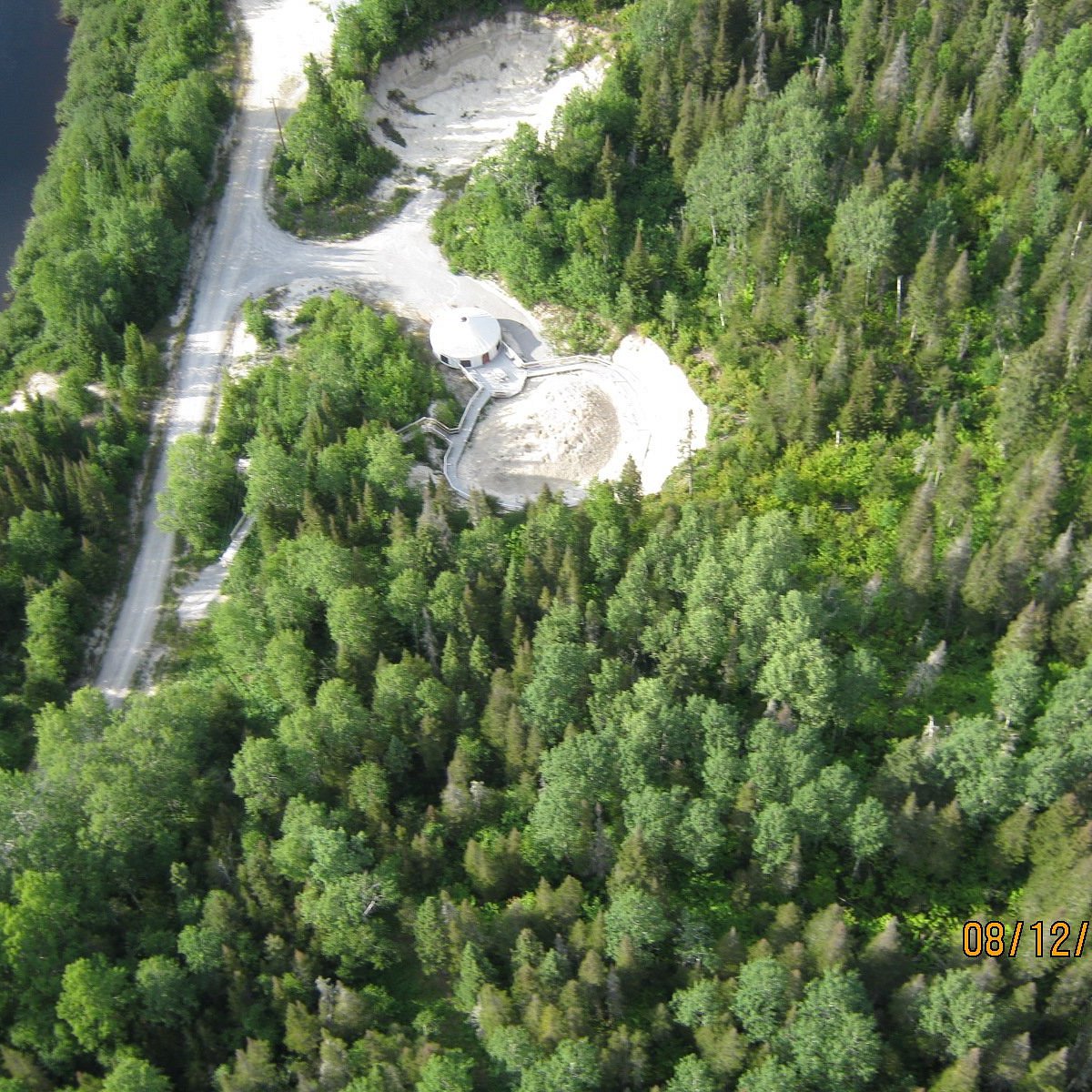 Mont Ti-Basse in Canada - an aerial view of a wooded area with trees and water.