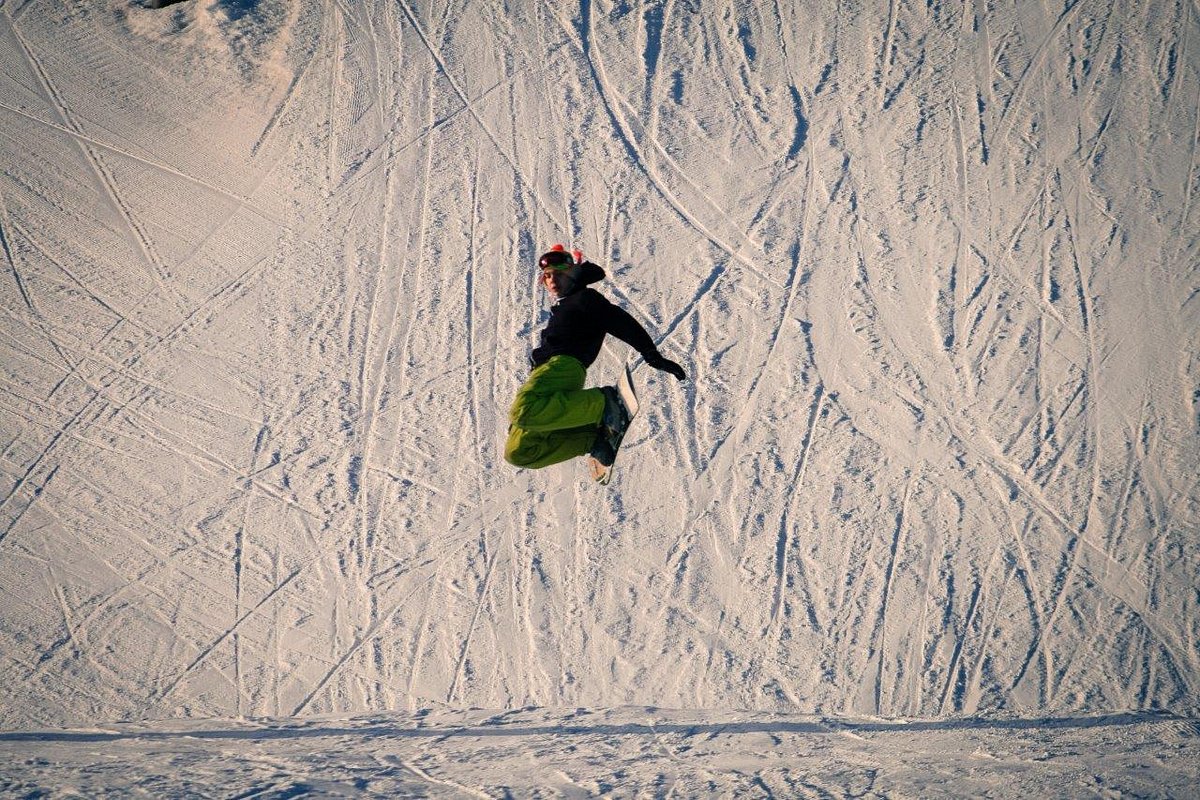 Birch Hill Ski & Snowboard Area in USA - a person jumping in the air on a snowboard.