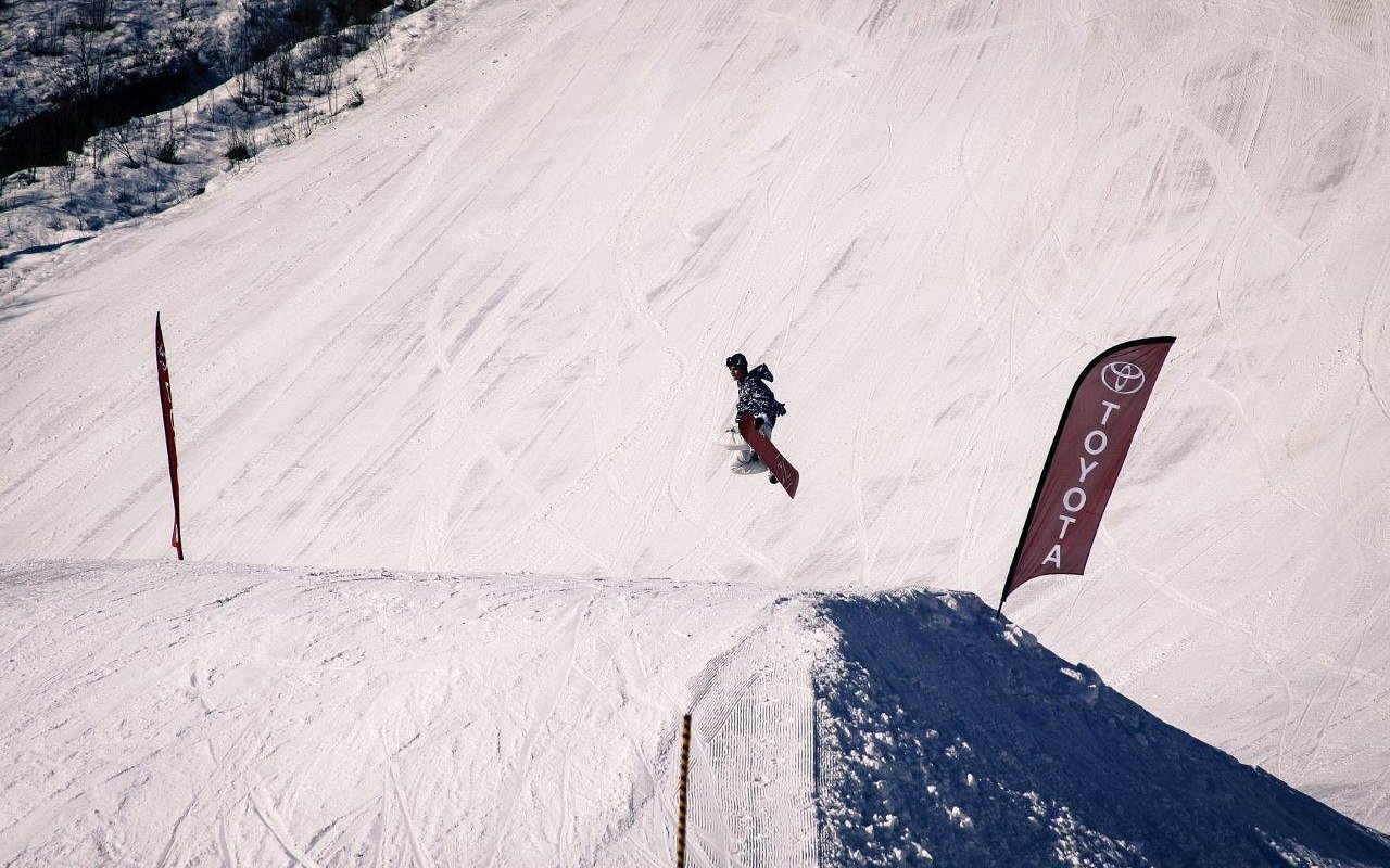 A snowboarder savoring a thrilling ride down the snowy slopes at Birch Hill Ski & Snowboard Area in Fort Wainwright, Alaska, USA.