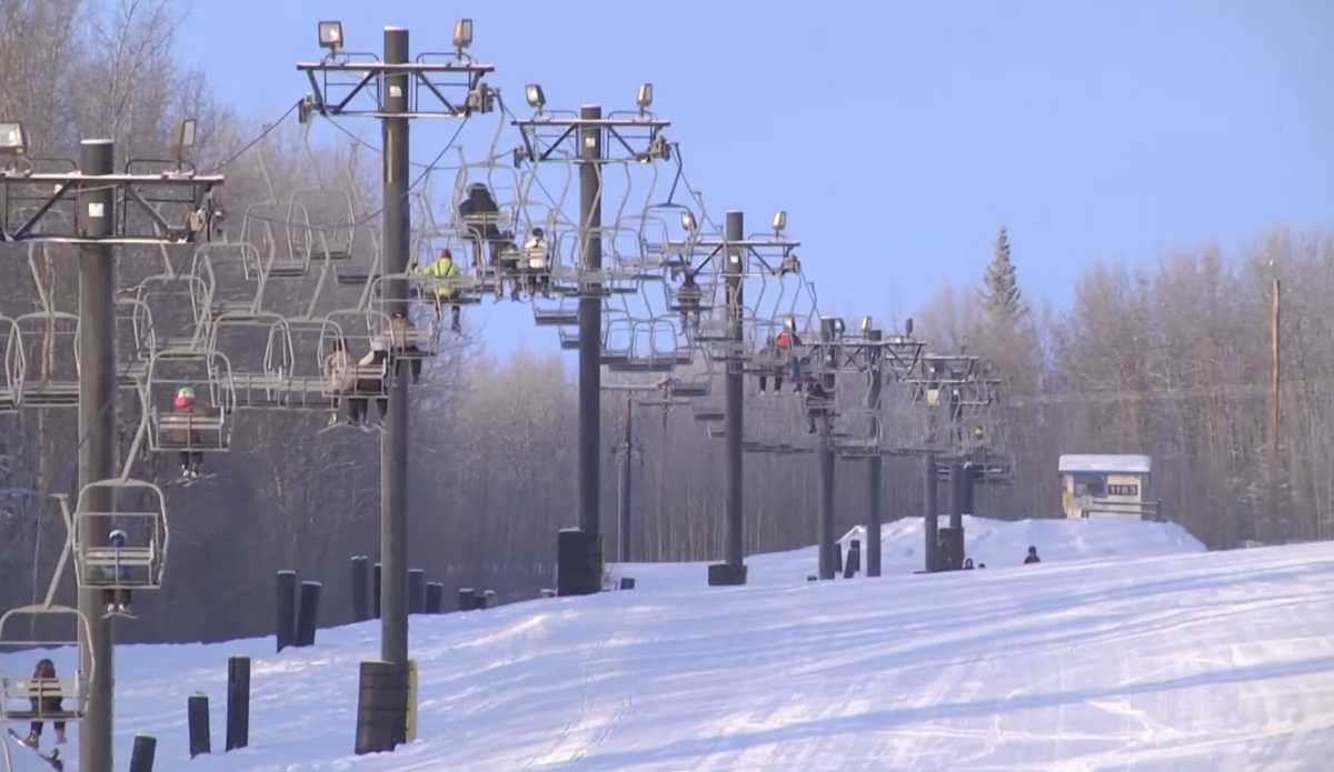 Birch Hill Ski & Snowboard Area in USA - a ski lift going down a snowy slope.