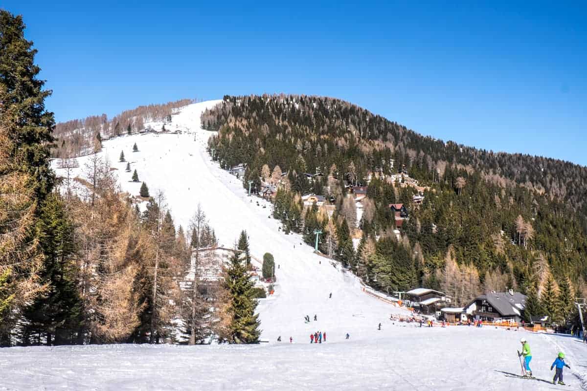 Gerlitzen Alpe in Austria - a group of people skiing down a mountain.