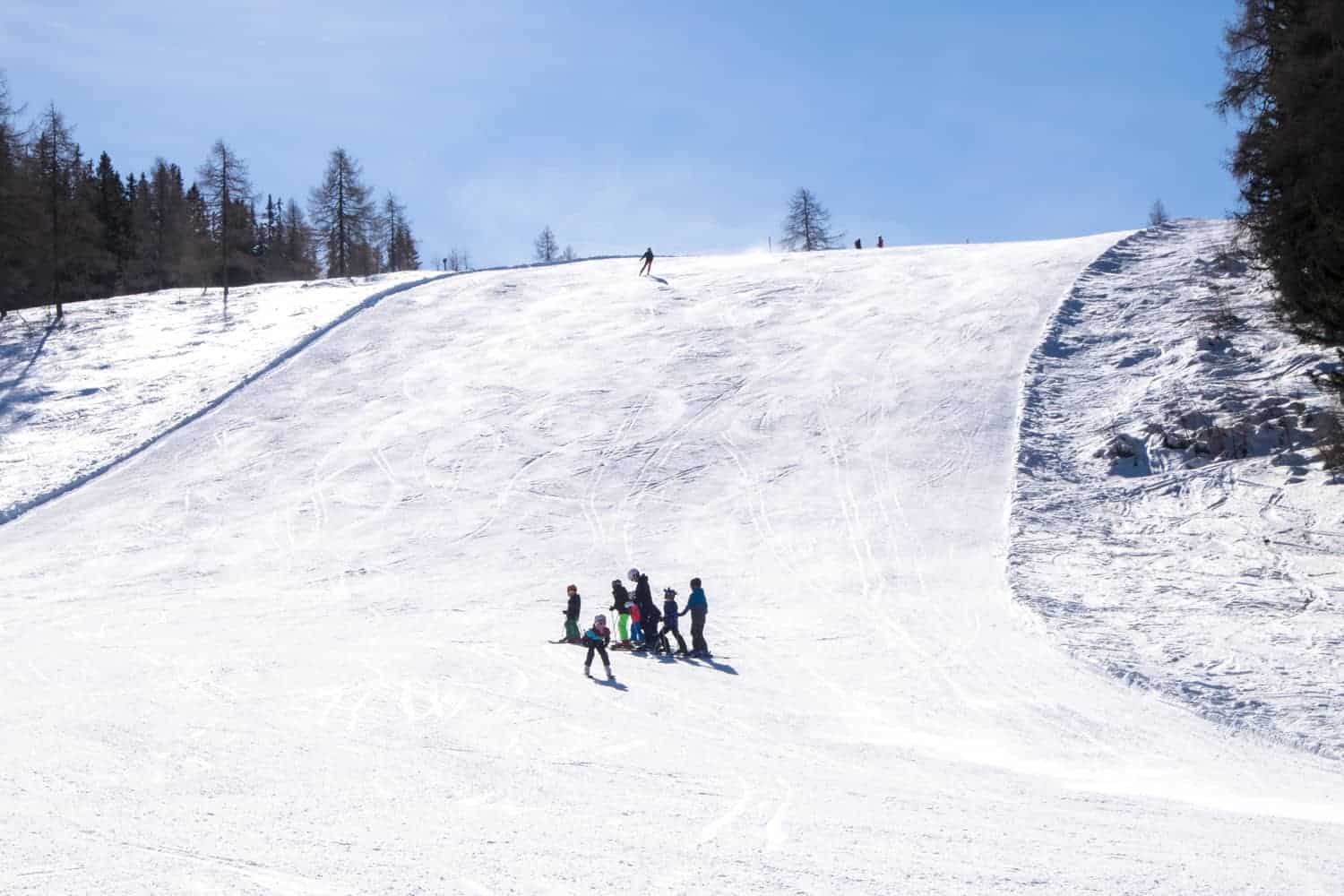 Gerlitzen Alpe in Austria - a group of people skiing down a snowy hill.