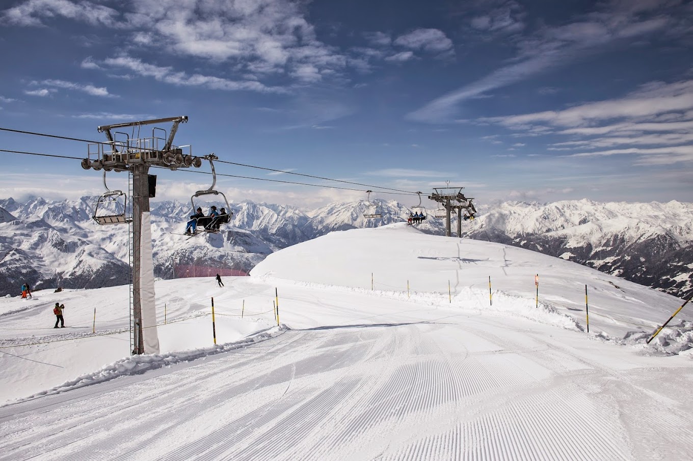Zillertal Arena – Zell am Ziller | ​Gerlos | ​Königsleiten | ​Hochkrimml in Austria - a ski lift going up a snowy slope.