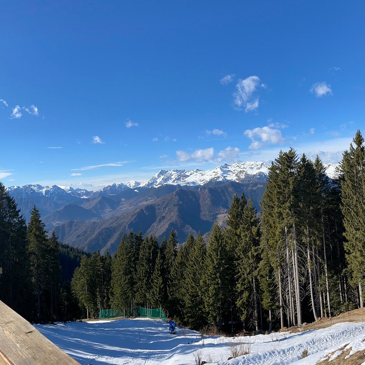 Piazzatorre in Italy - a man riding a snowboard down a snow covered slope.