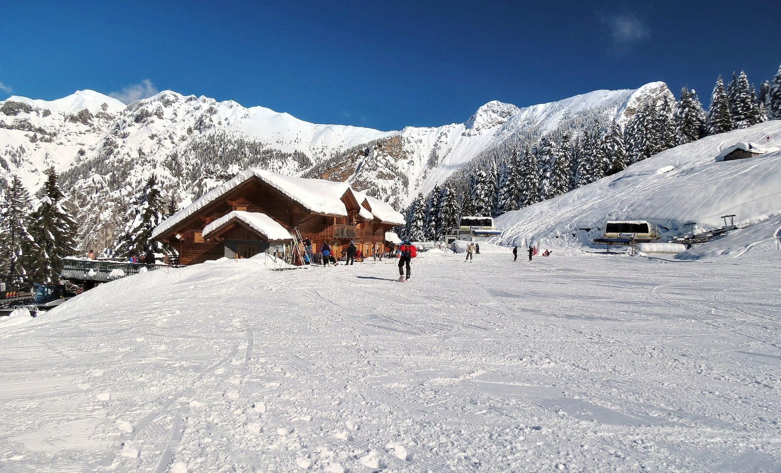 Piazzatorre in Italy - a group of people skiing down a snowy slope.
