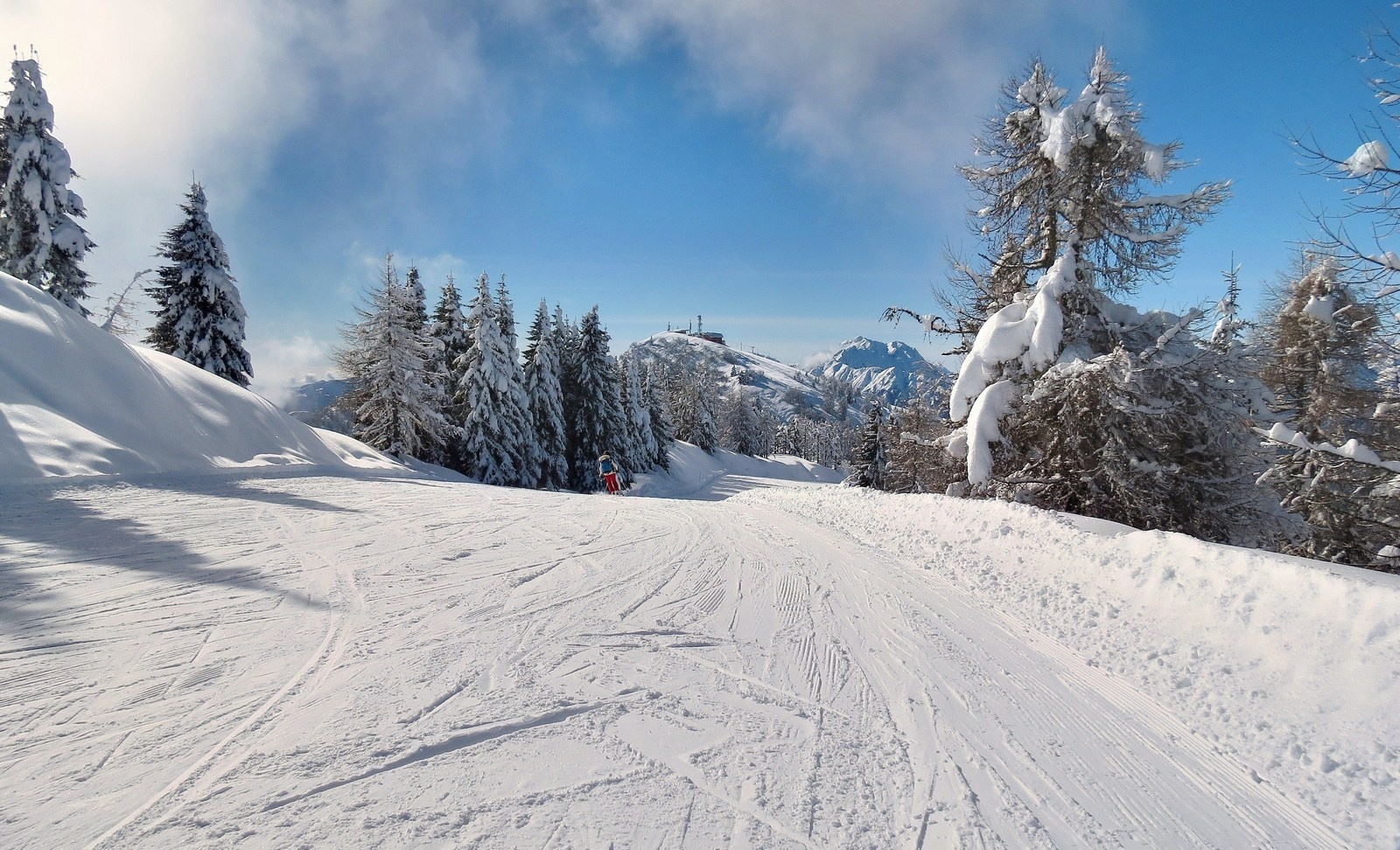 Piazzatorre in Italy - a person riding a snowboard down a hill.