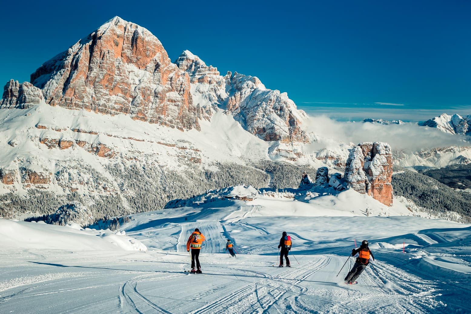 Piazzatorre in Italy - a group of people skiing down a snowy mountain.