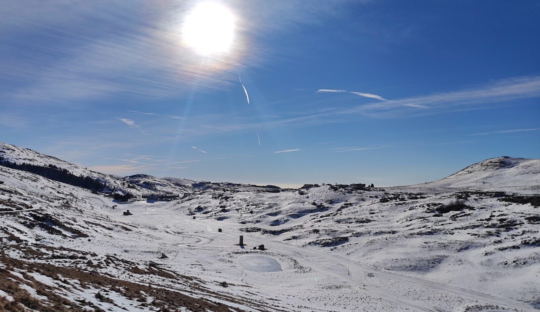 Winter sports scene at Malga San Giorgio with snow-covered chalet amidst stunning winter scenery, a popular winter sports centre in Verona, Italy.