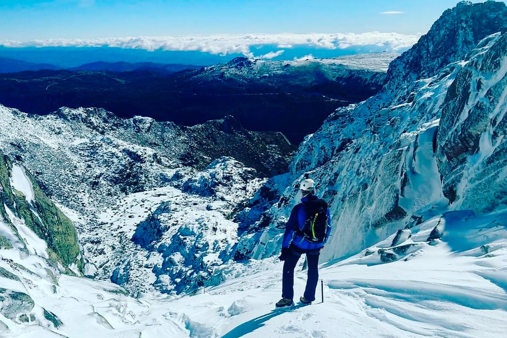Serra da Estrela in Portugal - a person standing on top of a snow covered mountain.