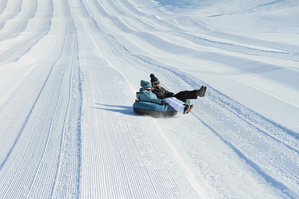 Perfect North Slopes in USA - a person sled down a snow covered hill.