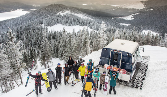 Winter sports scene at Mont Miller in Quebec featuring a bustling ski resort with a ski lift. Groups of people, including families, enjoy a day of skiing against a stunning landscape.