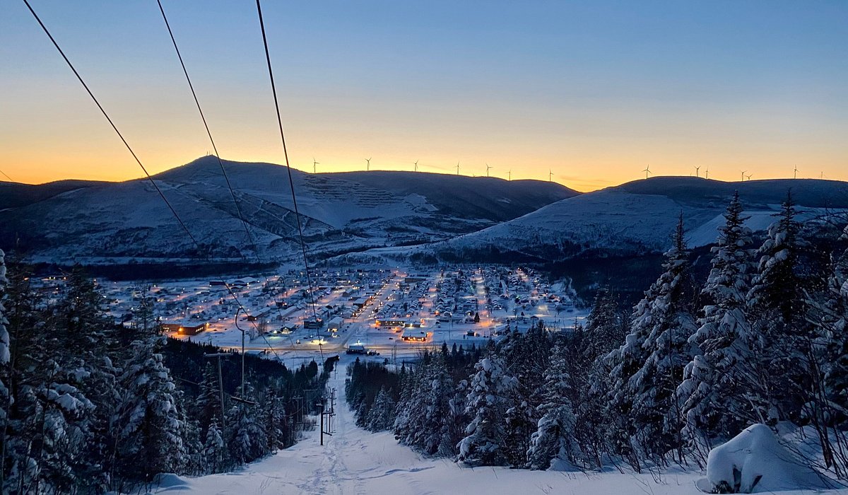 Mont Miller in Canada - a ski lift going up a snowy hill at sunset.