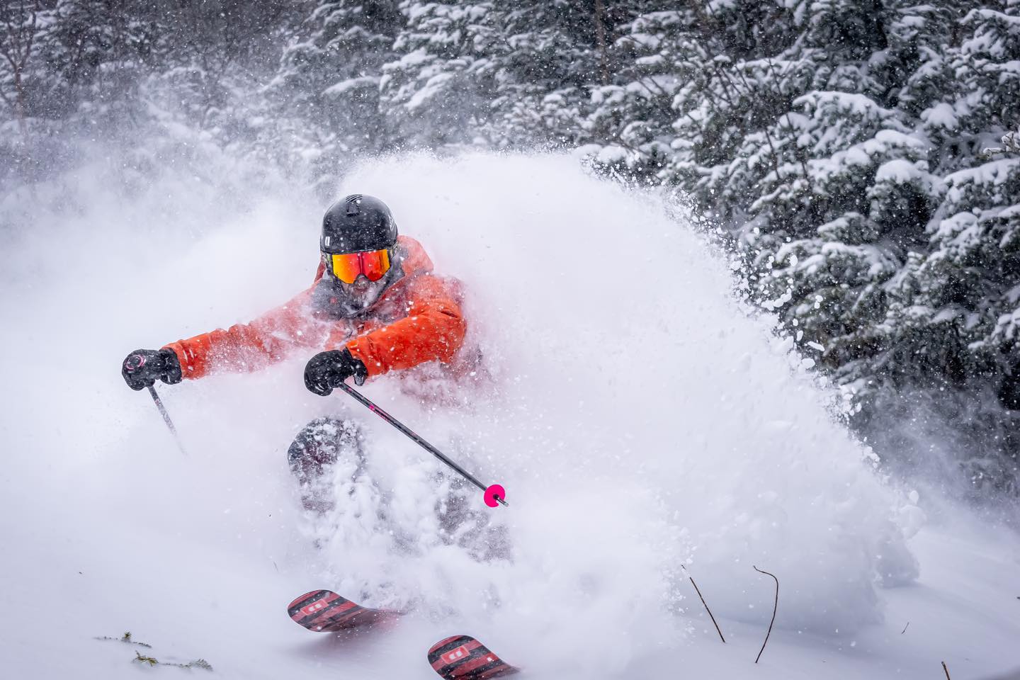 Mont Miller in Canada - a person in an orange jacket skiing down a hill.