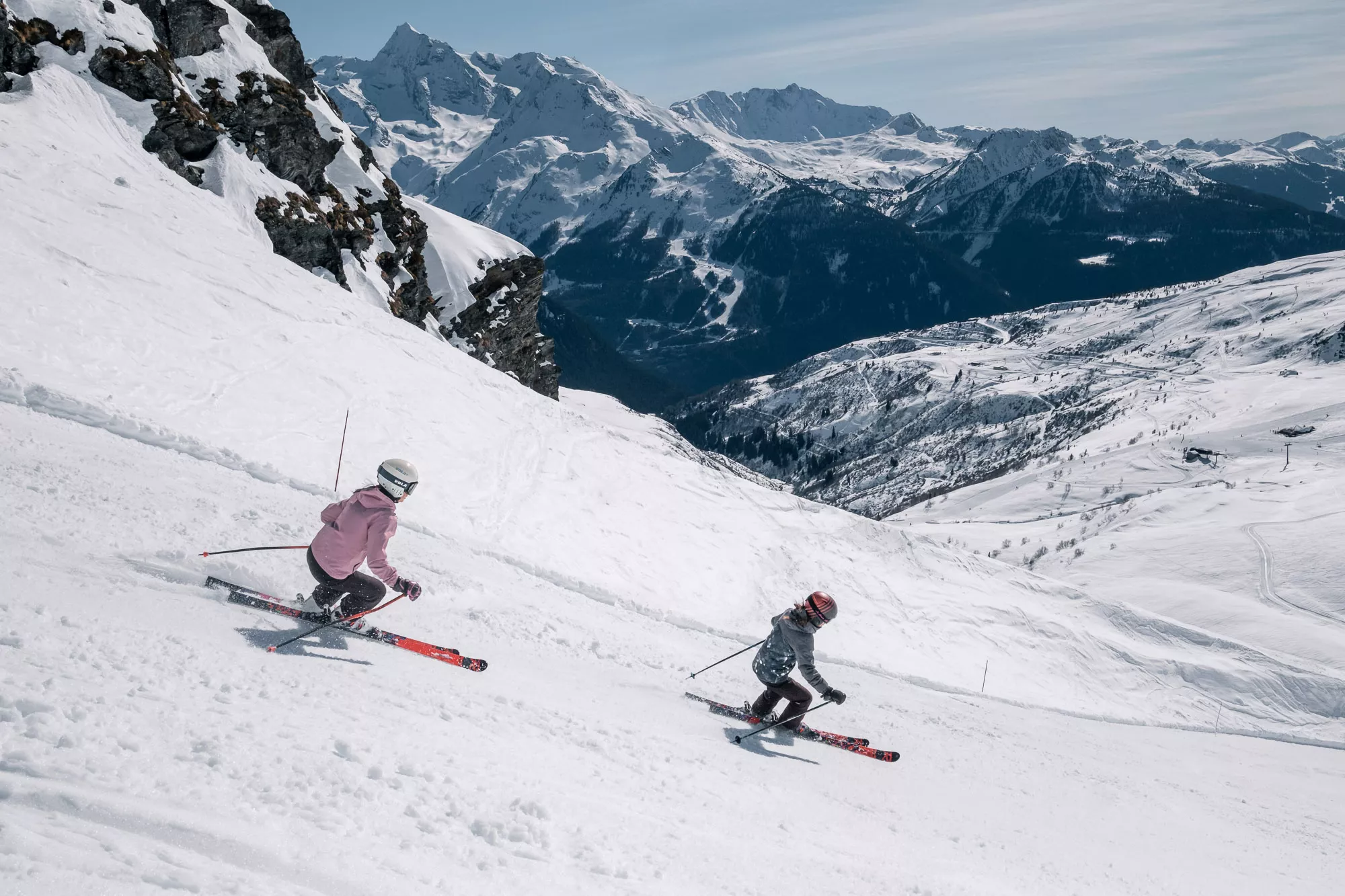 A skier navigating the snow-covered slopes at the Ruine Super Saint-Bernard ski resort in Switzerland accompanied by a group of skiers giving off a family-friendly winter sports vibe.