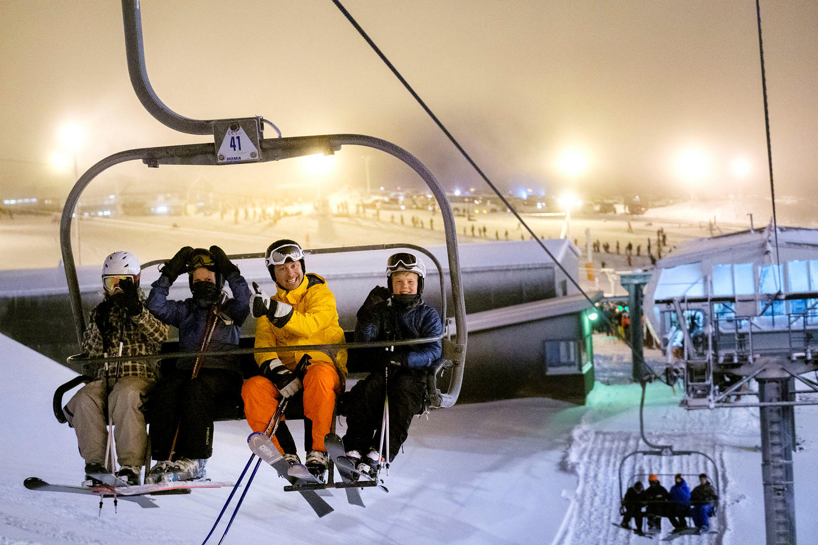 Skálafell in Iceland - a group of people sitting on a ski lift.