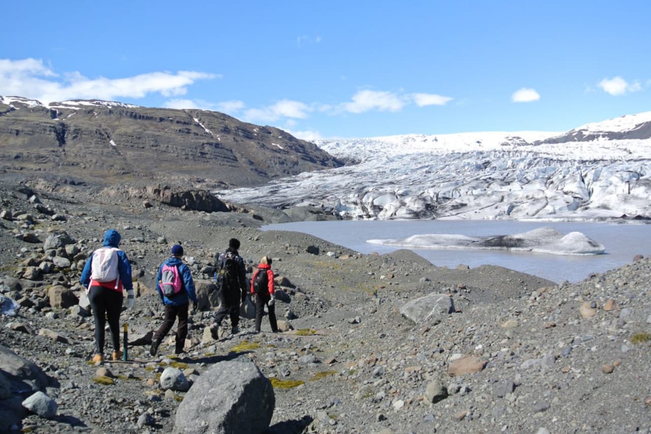 Skálafell in Iceland - a group of people walking across a rocky area.