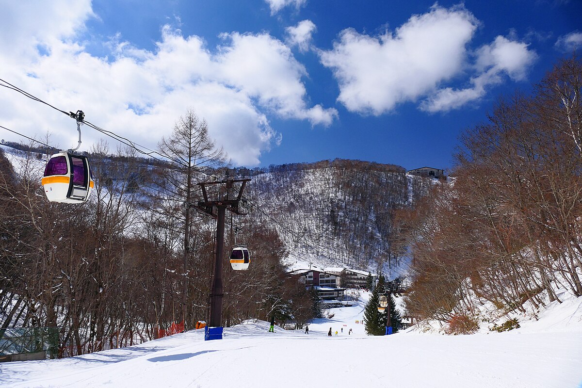 Hoppo-Bunadaira Ski Area in Japan - a ski lift going up a snowy hill.