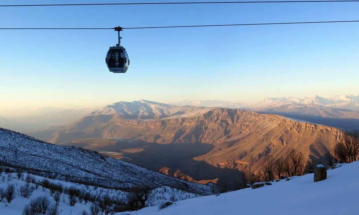 Ski lift at a resort in Dohuk, Khalifan, Erbil Governorate, Iraq. The scene depicts a captivating winter sports location with a cosy chalet and beautiful snow-covered surroundings.