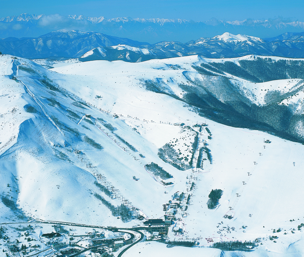 Chateraise Ski Valley Koumi in Japan - a view of a snow covered mountain range.
