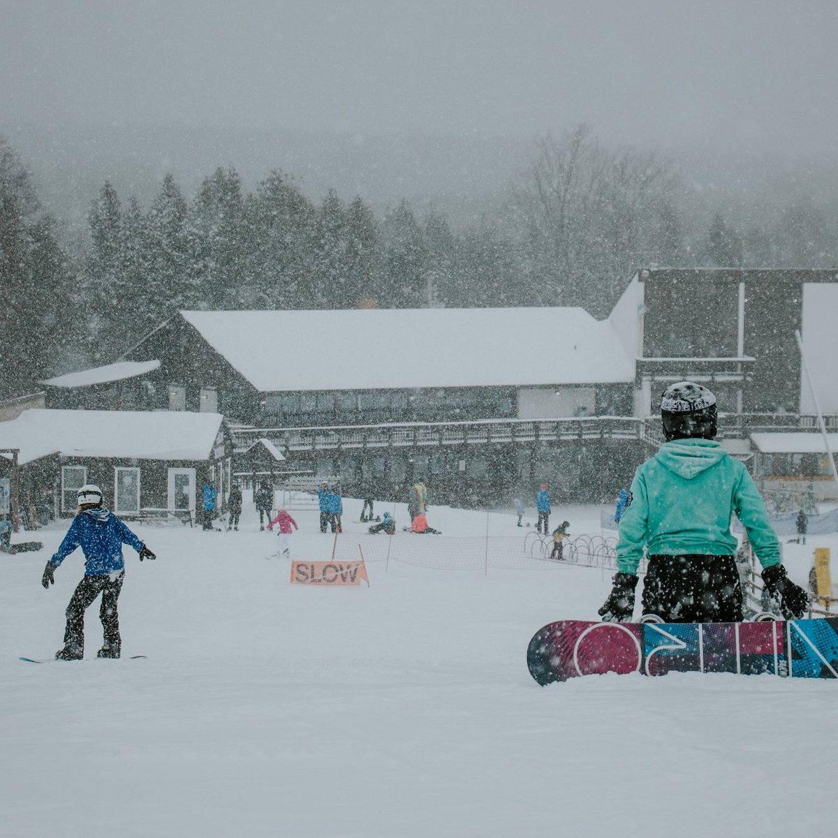 Brimacombe in Canada - a group of people riding snowboards down a snow covered slope.