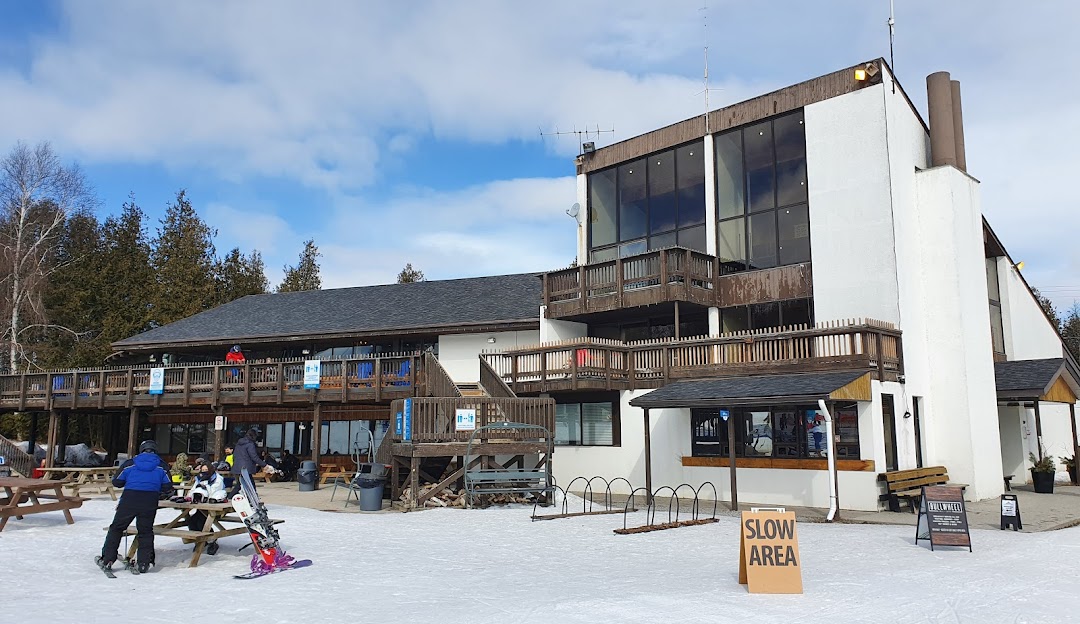 Brimacombe winter sports centre in Orono, Ontario, featuring a ski resort, a challet, and a lodge amidst a scenic winter landscape.