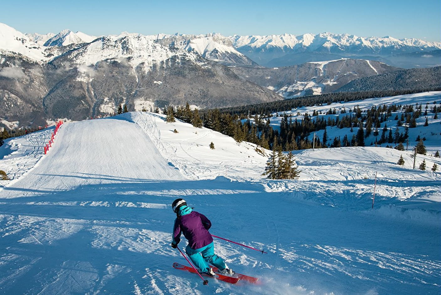 Aillon-le-Jeune in France - a person on a snowboard going down a hill.