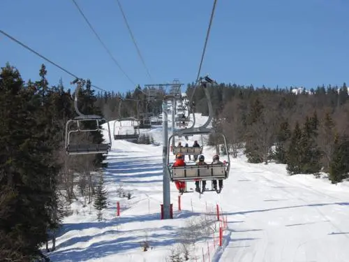 Aillon-le-Jeune in France - a ski lift going down a snowy slope.