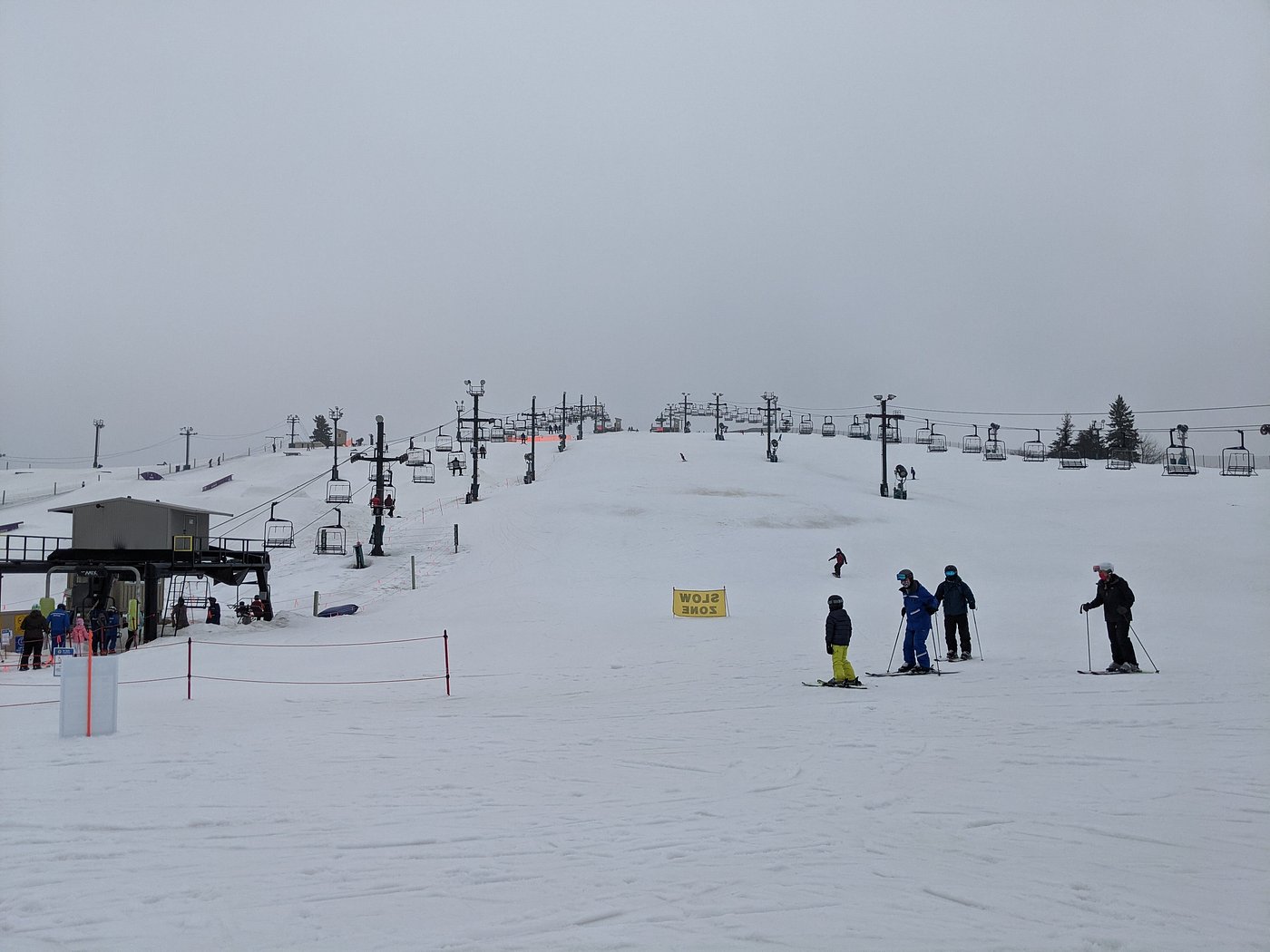 Mt Brighton in USA - a group of people skiing down a snowy hill.