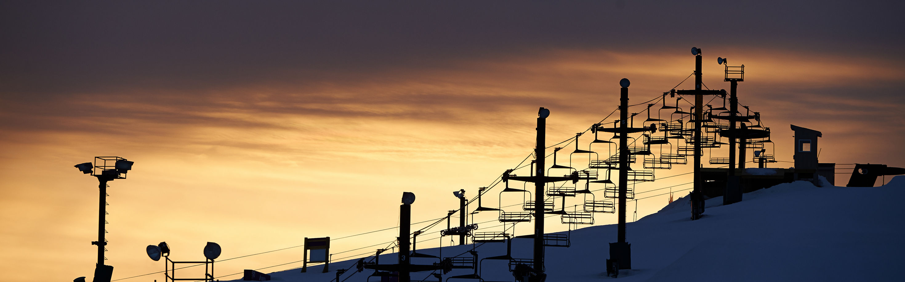 Mt Brighton in USA - a ski lift going up a snowy slope.