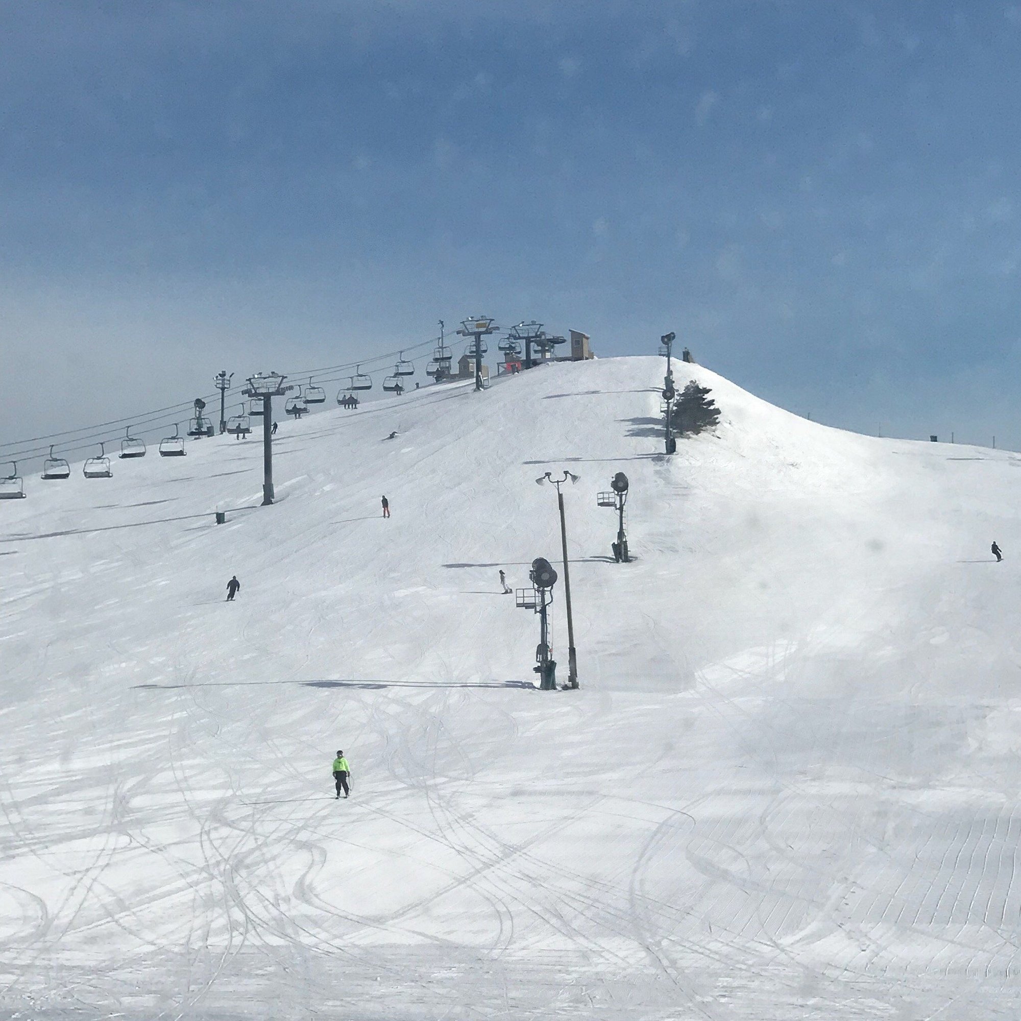 Mt Brighton in USA - a group of people skiing down a snowy hill.
