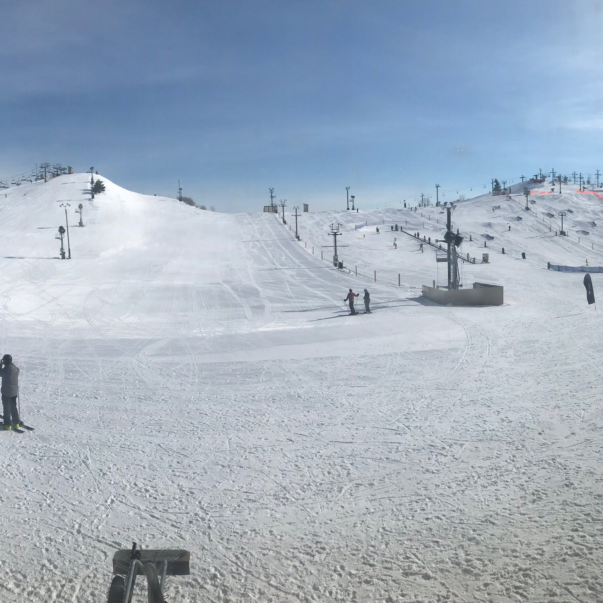 Mt Brighton in USA - a group of people skiing down a snow covered hill.