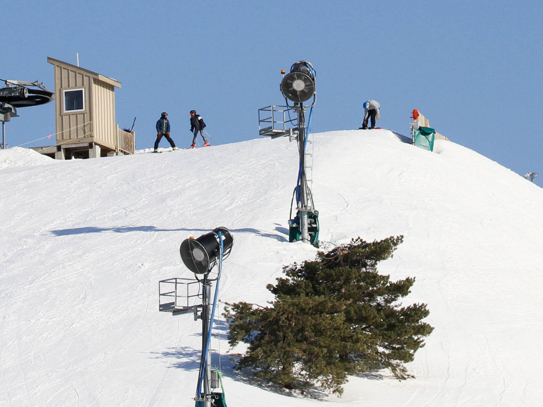 Mt Brighton in USA - a group of people standing on a snow covered hill.