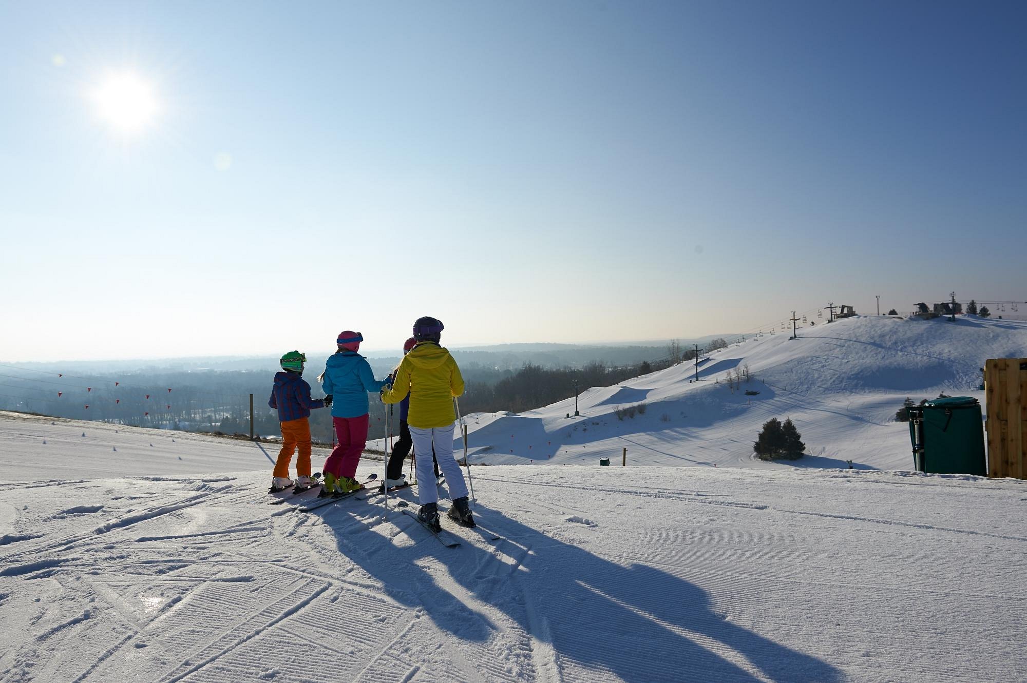 Mt Brighton in USA - a group of people skiing down a snow covered hill.