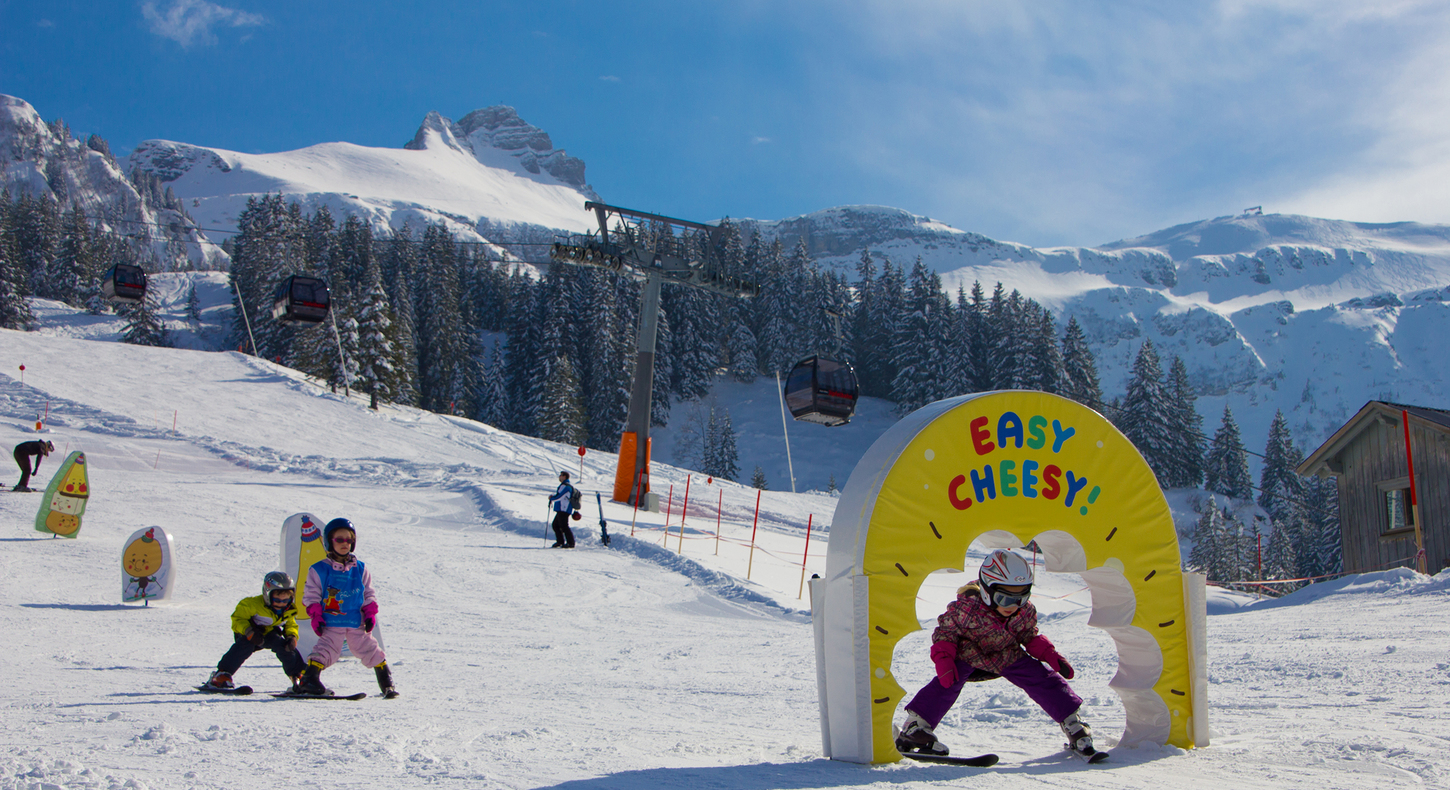 Faschina in Austria - a group of people riding down a snow covered slope.
