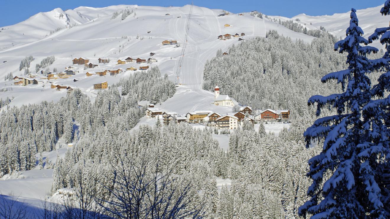 Faschina in Austria: a ski resort surrounded by snow covered trees.