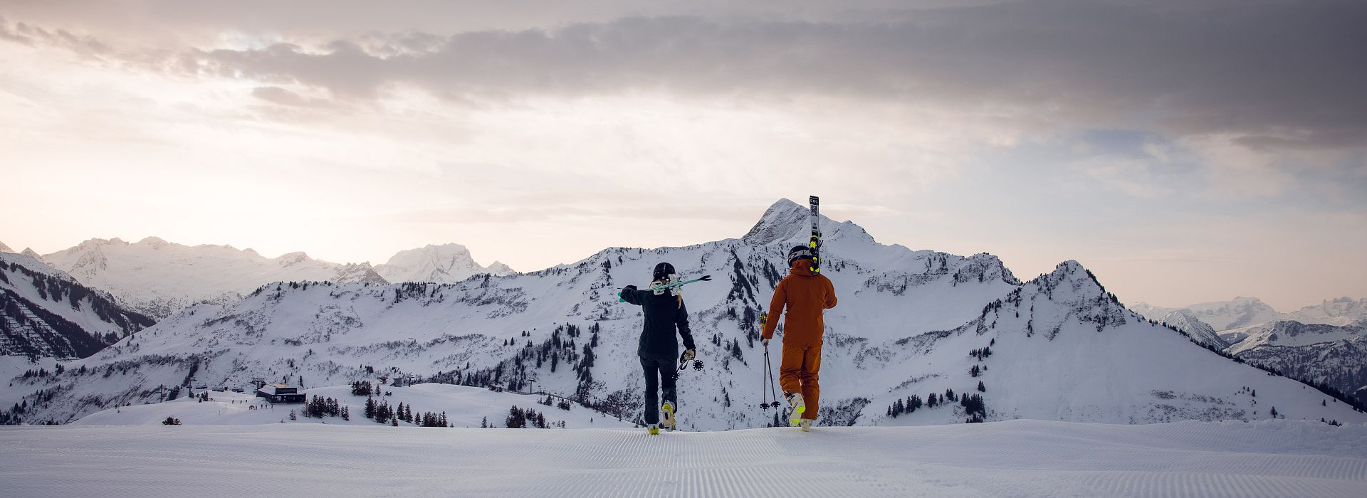 Faschina in Austria - two people standing on top of a snowy mountain.