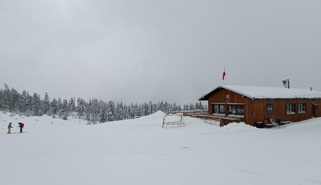 Katzenkopf Leutasch in Austria - a person skiing in the snow near a cabin.