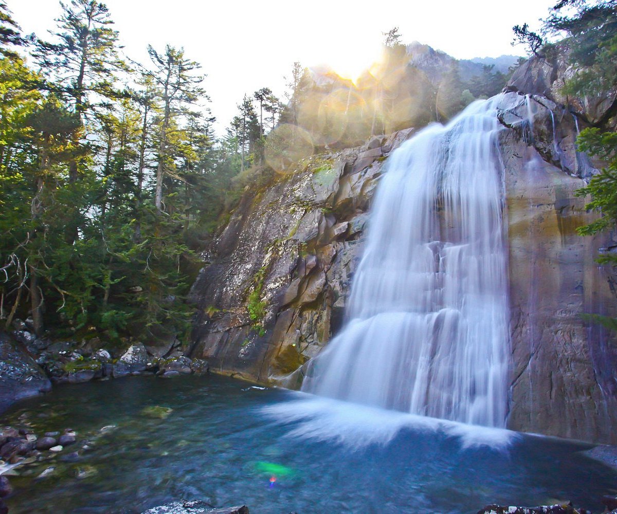 Pont d'Espagne in France - a waterfall in the middle of a forest.