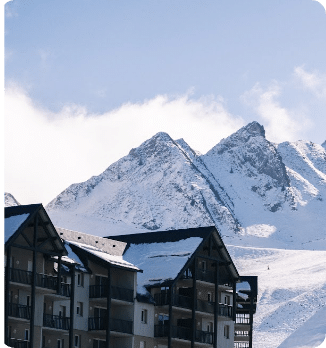 A ski resort nestled in the majestic mountains of Peyragudes Hautes-Pyrénées France bustling with winter sports enthusiasts. A charming chalet adds to the scenic beauty of the snow-clad landscape.