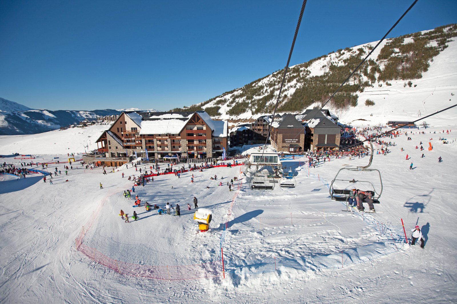 Peyragudes in France - a group of people skiing down a snowy hill.