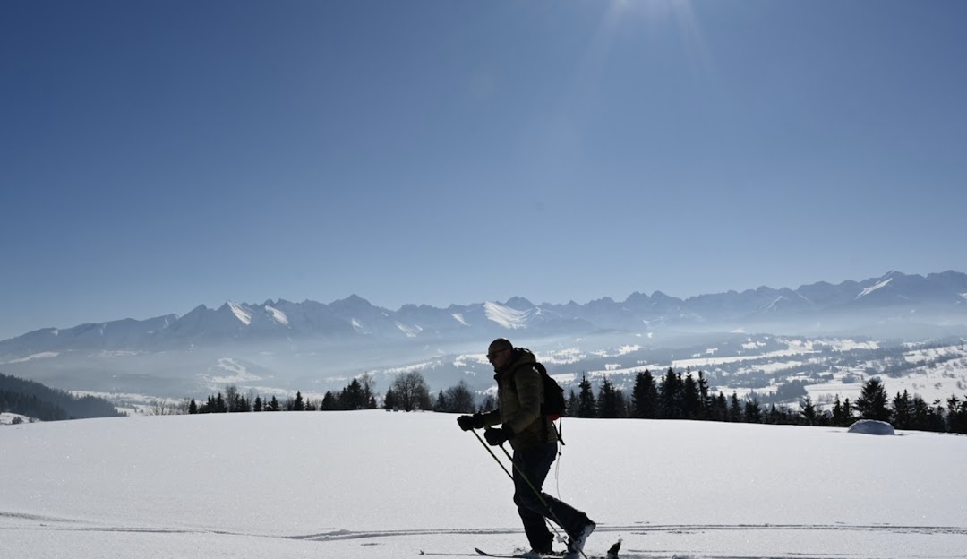 Stacja Narciarska GrapaSki in Poland - a person walking across a snow covered field.