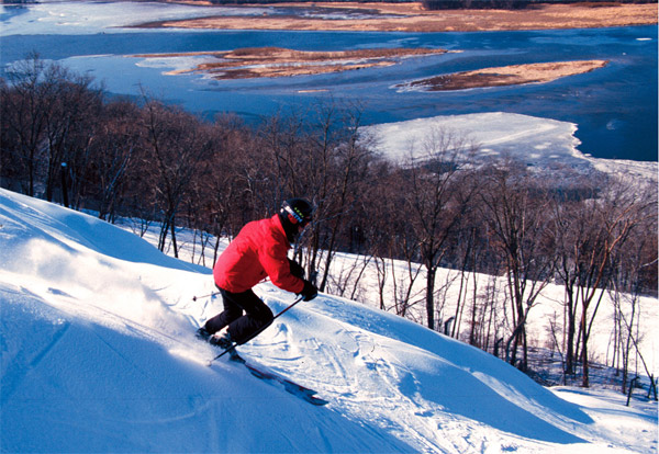 Chestnut Mountain in USA - a person is skiing down a snowy hill.