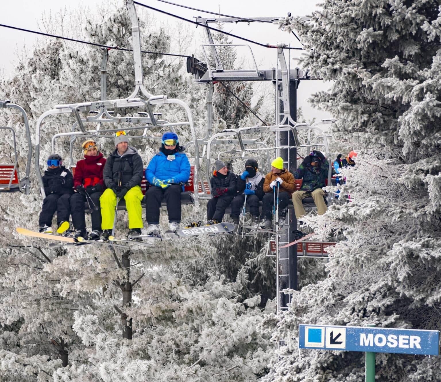 Chestnut Mountain in USA - a group of people riding a ski lift in the snow.