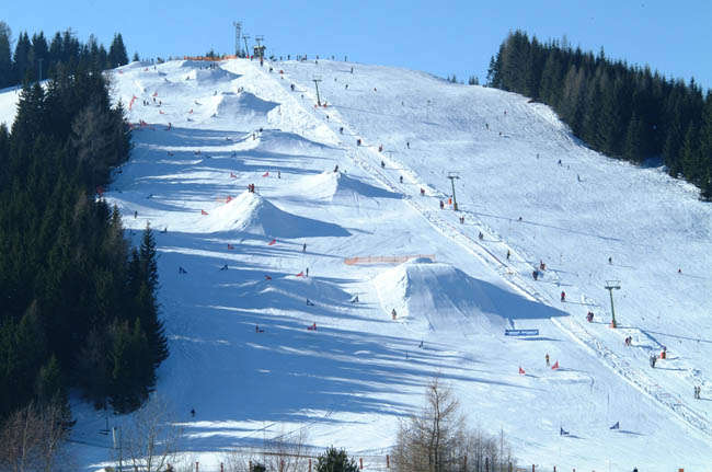 Simonhöhe in Austria - a group of people skiing down a mountain.