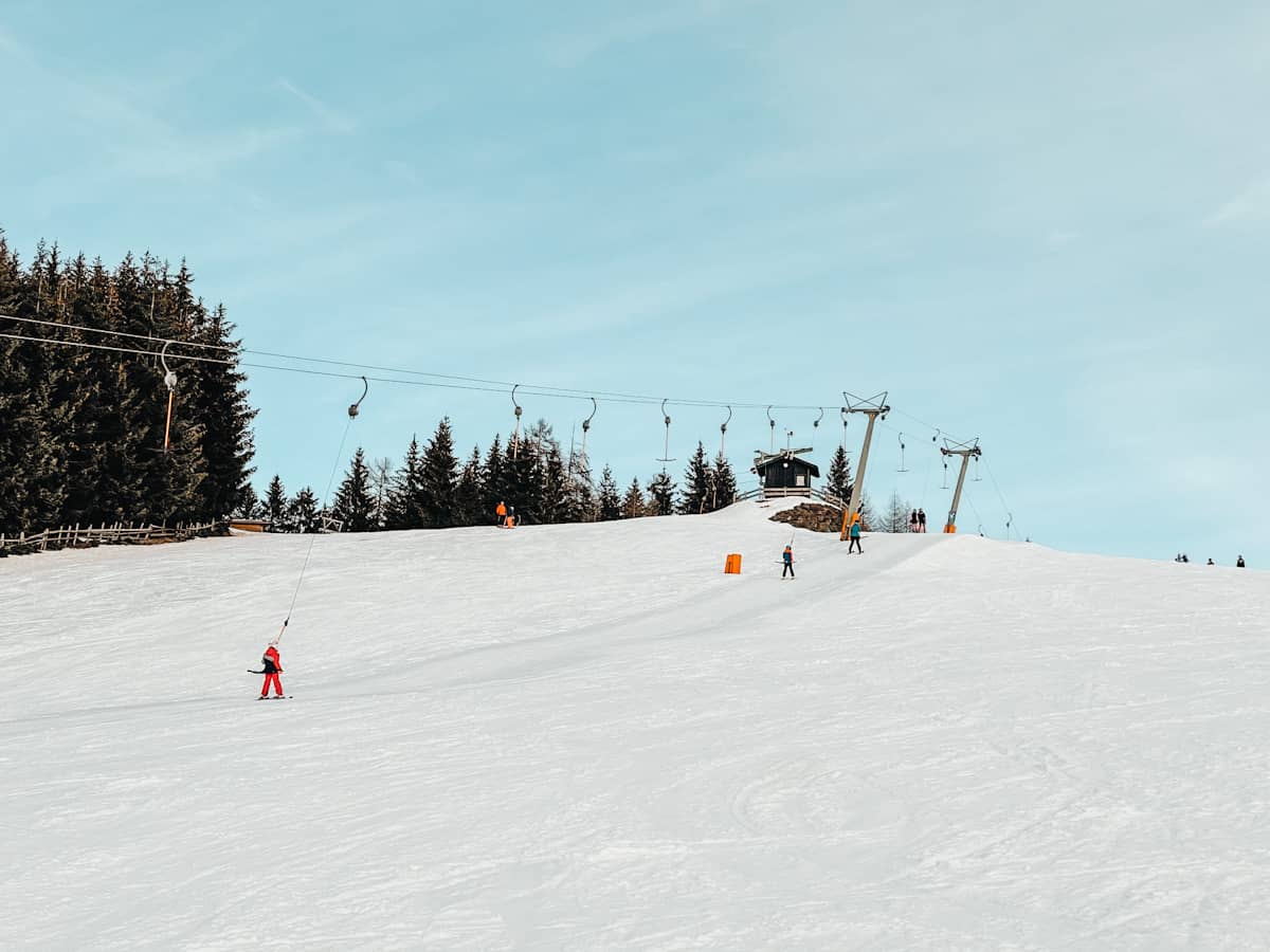 Simonhöhe in Austria - a person skiing down a snowy hill.