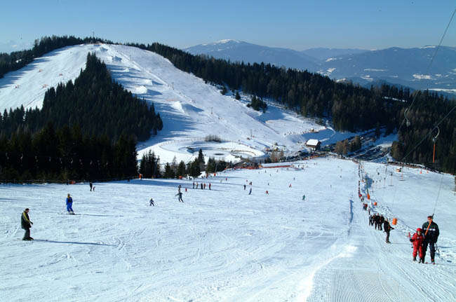 Simonhöhe in Austria - a group of people skiing down a snowy slope.