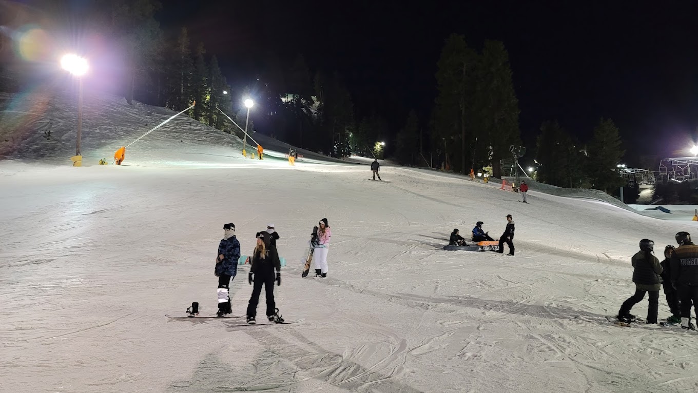 Mountain High North in USA - a group of people skiing down a snow covered hill.