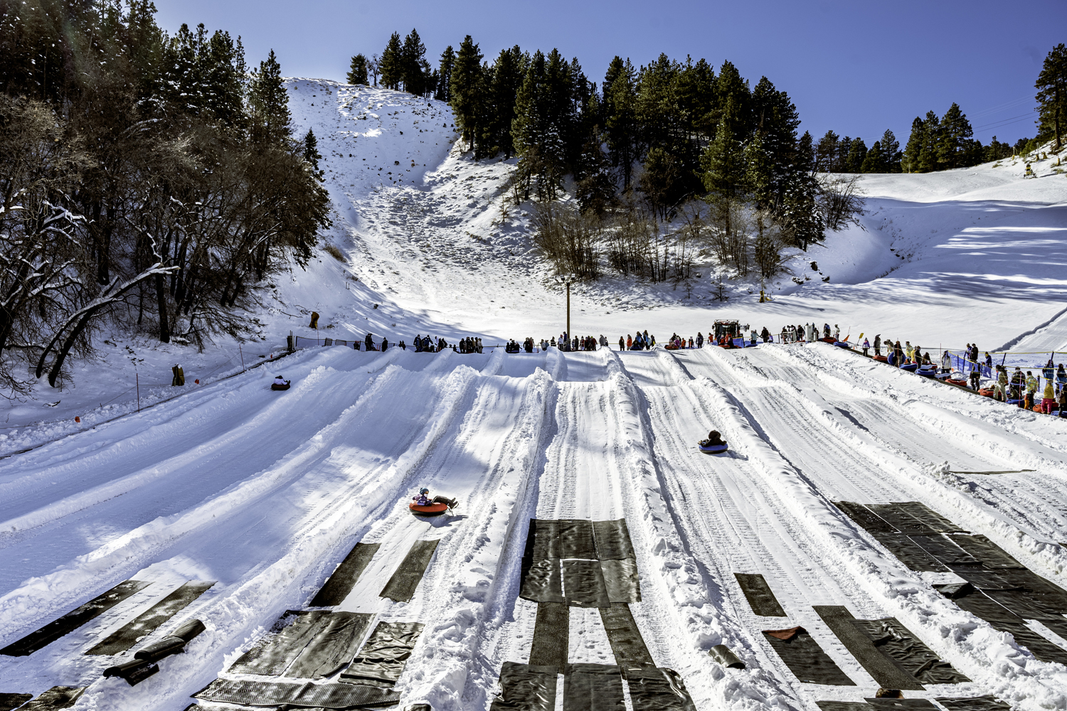 Mountain High North in USA - a group of people skiing down a snowy hill.