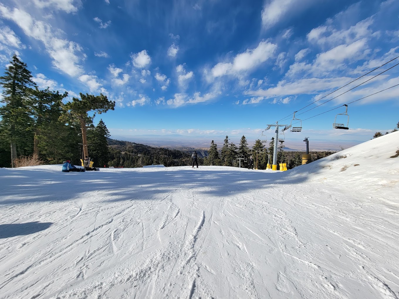 Mountain High North in USA - a snow covered ski slope with trees in the background.