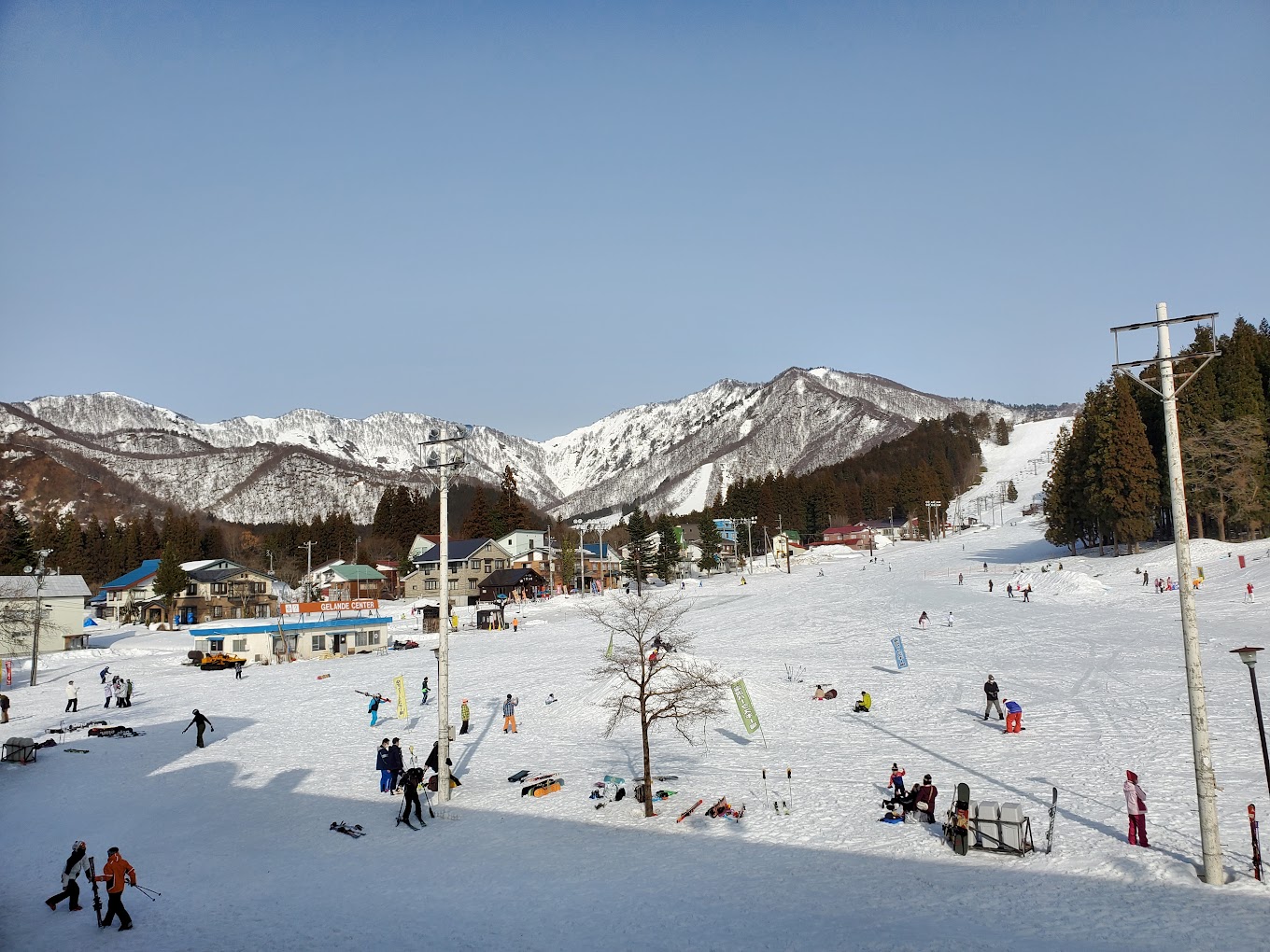 Yuzawa Park in Japan - a group of people skiing down a snowy slope.